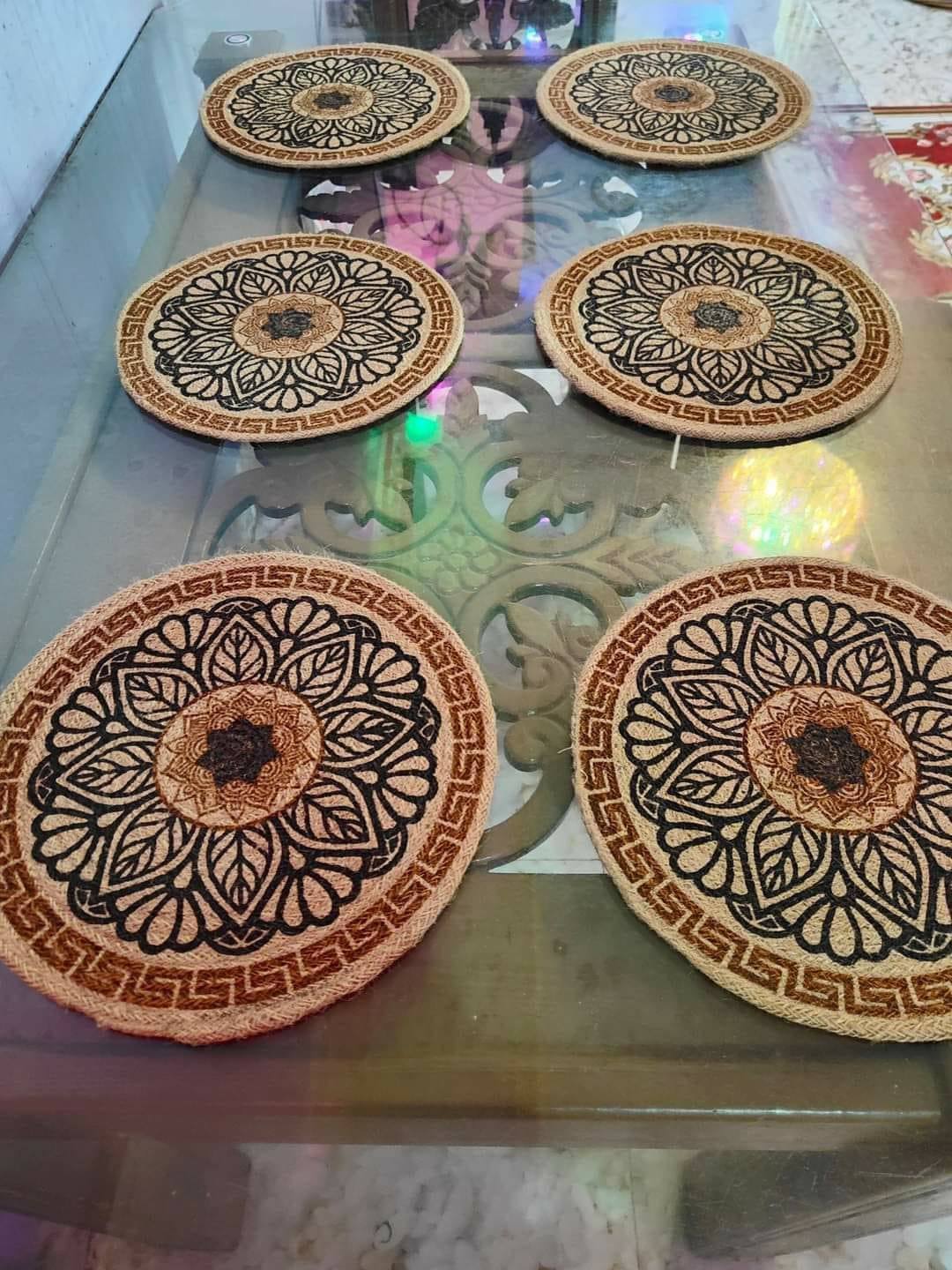 Round jute mats with leaf mandala patterns
